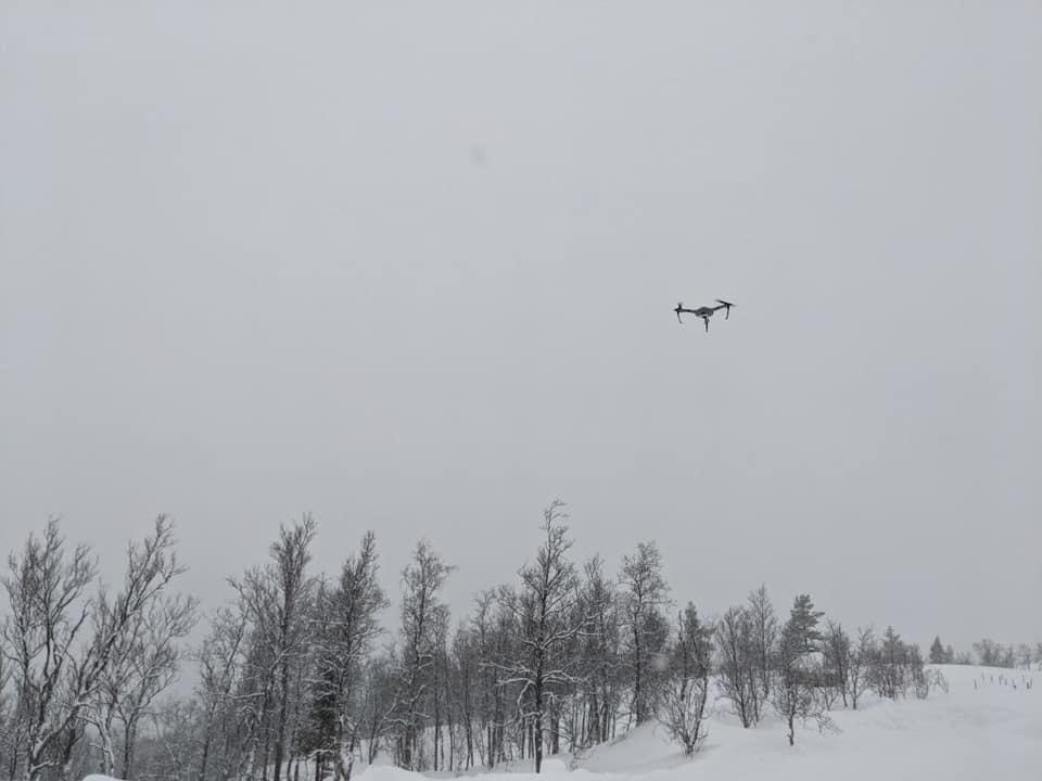 A person flying through the air on a snow covered slope  Description automatically generated